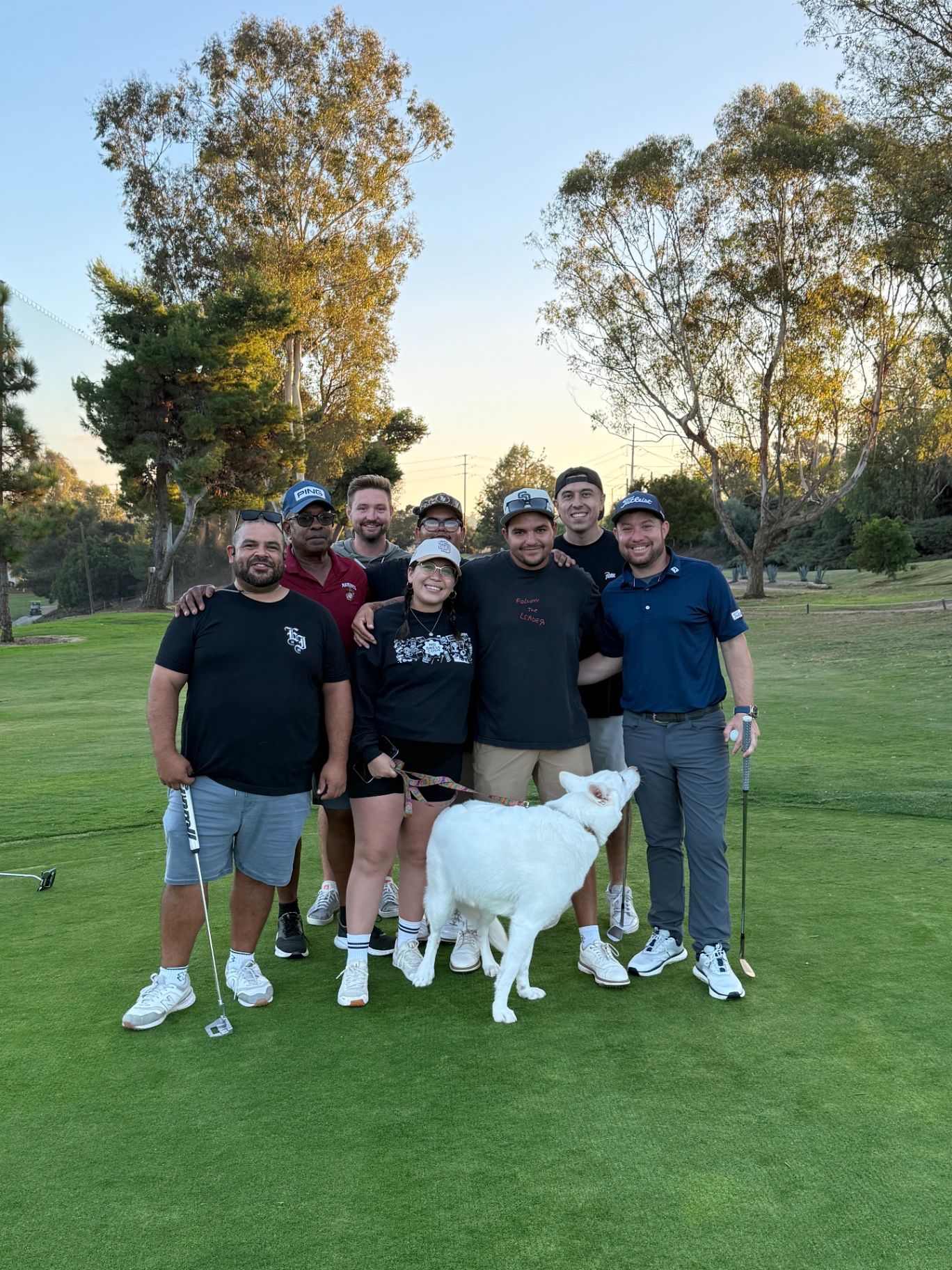 Group on the course at dusk